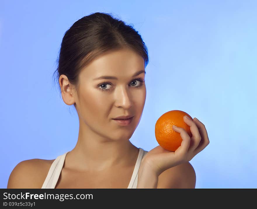 The woman with an orange fruit isolated