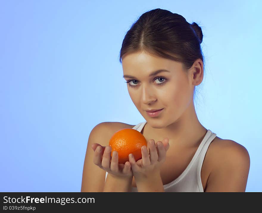 The woman with an orange fruit isolated