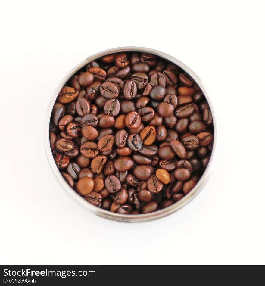 Coffee beans in round metallic disk isolated on white. Coffee beans in round metallic disk isolated on white