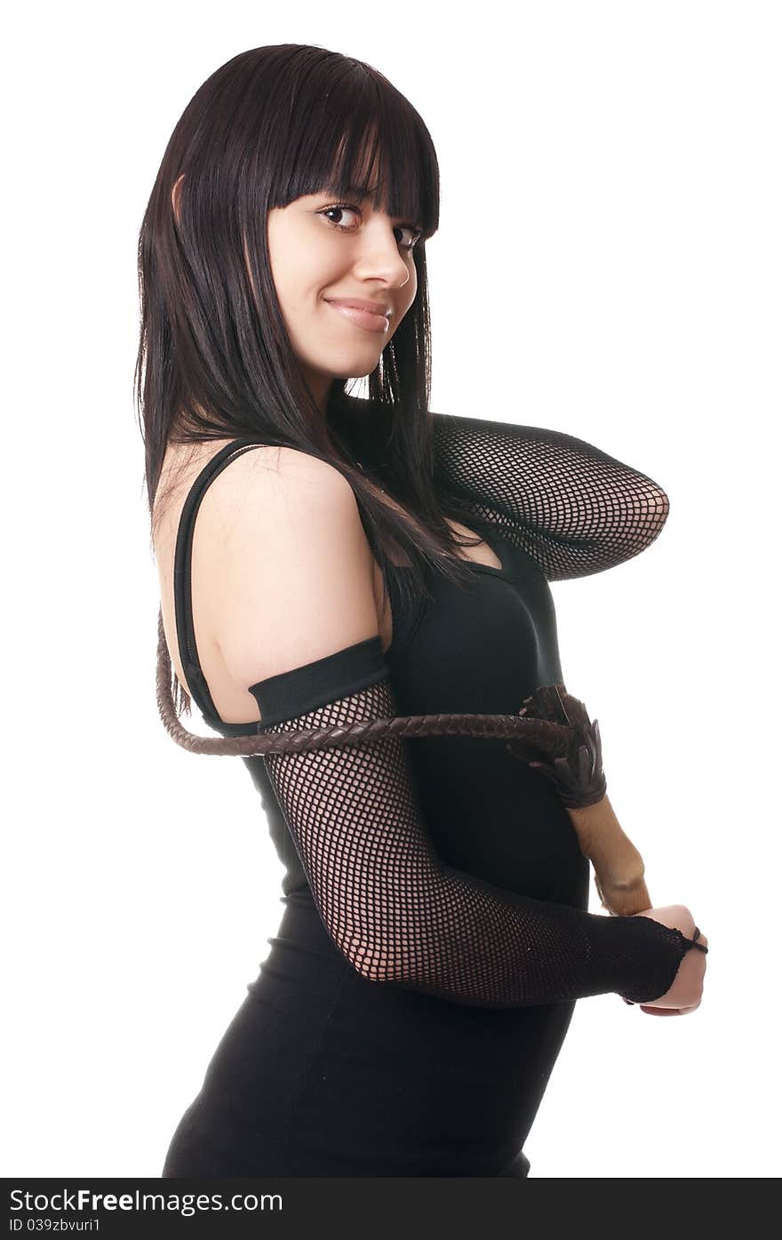 Beautiful woman in black dress with whip posing, studio shot. Beautiful woman in black dress with whip posing, studio shot