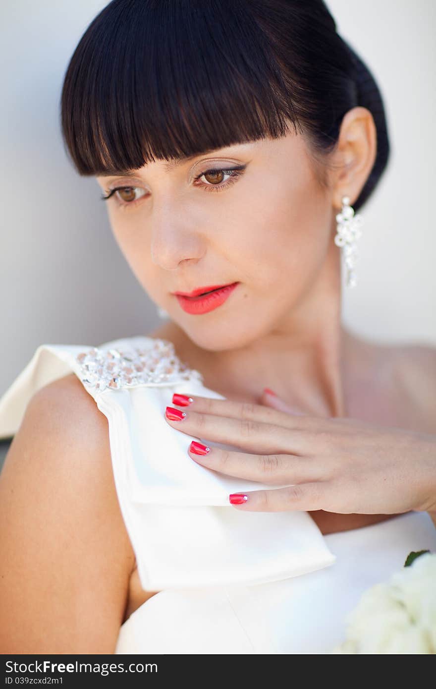 Pretty bride near the wall