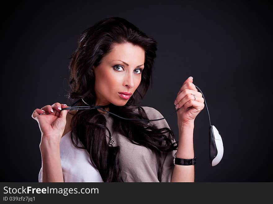 Attractive girl entwined cord holding a computer mouse