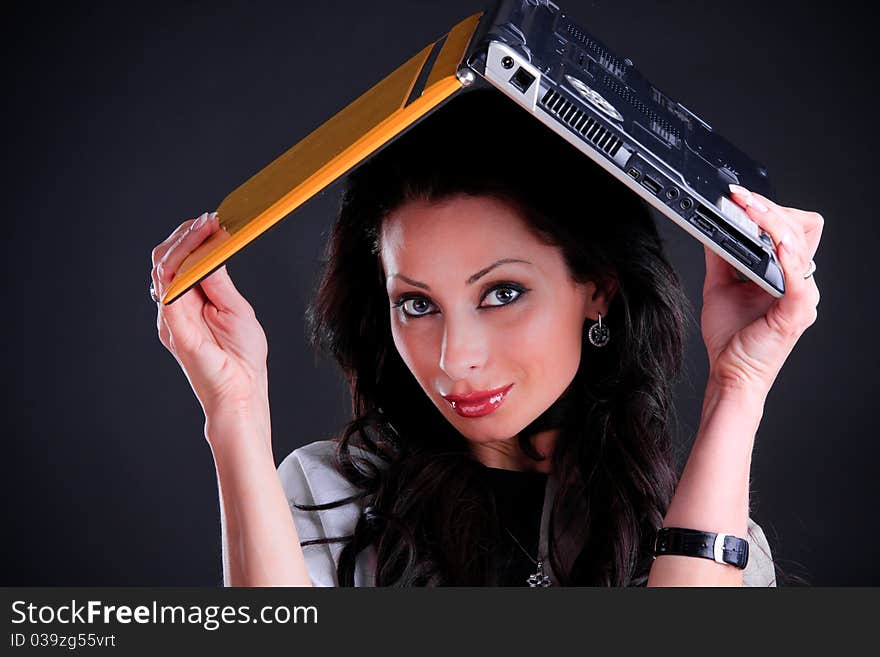 Beautiful brunette fooling around with a yellow notebook