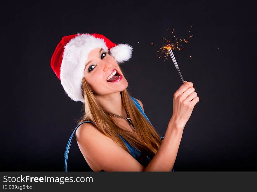 Cute girl in Santa hat holding sparklers. Cute girl in Santa hat holding sparklers