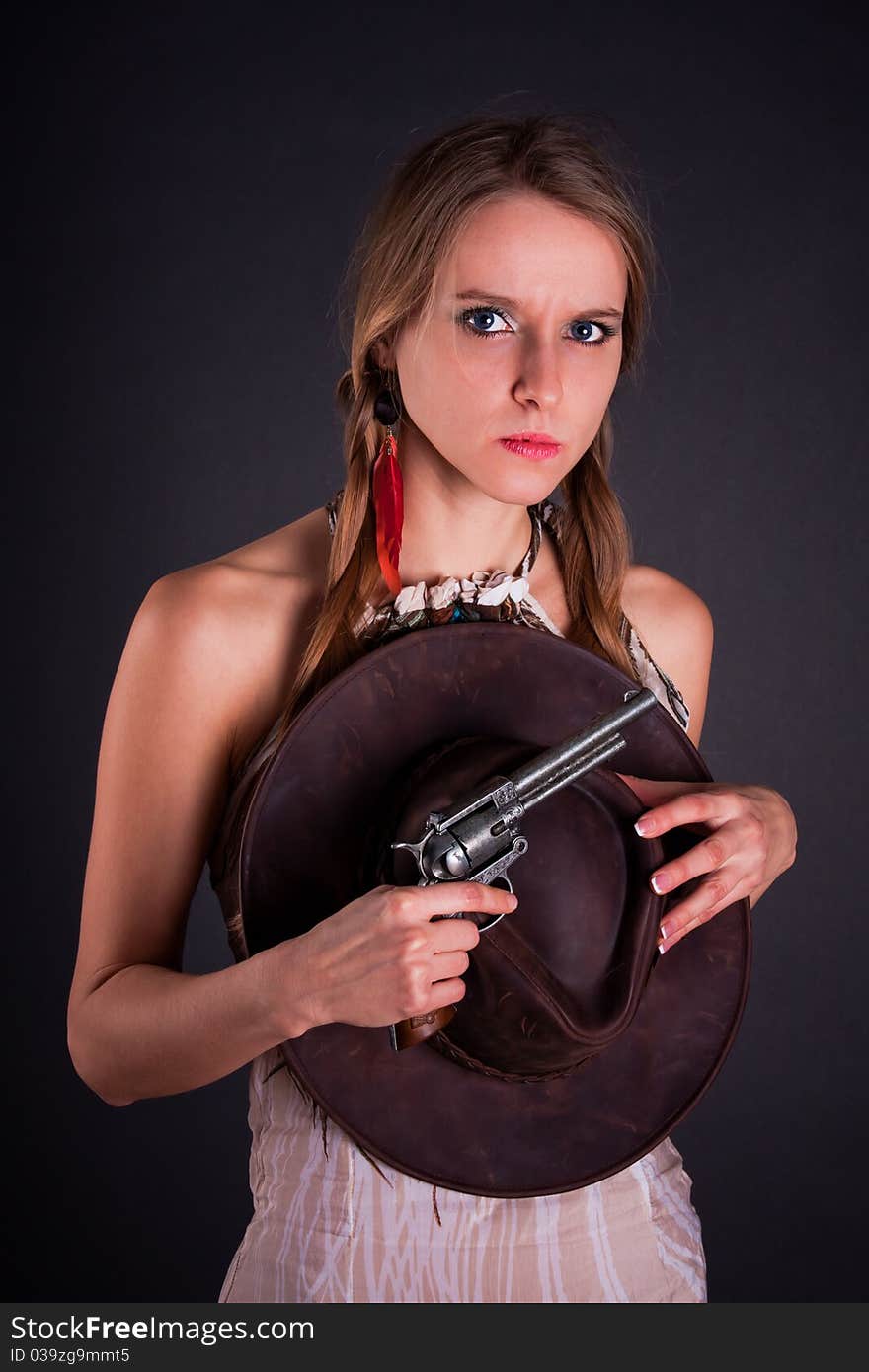 The American Indian girl with a cowboy's hat holds a pistol