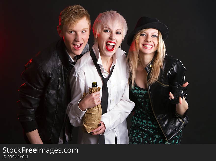 Young festive group of friends against black background