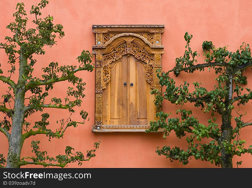 Wooden window asian style on a pink wall