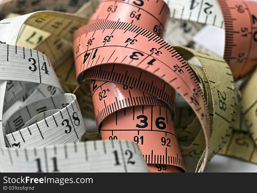 Background of tangled and entwined tapemeasures. Background of tangled and entwined tapemeasures