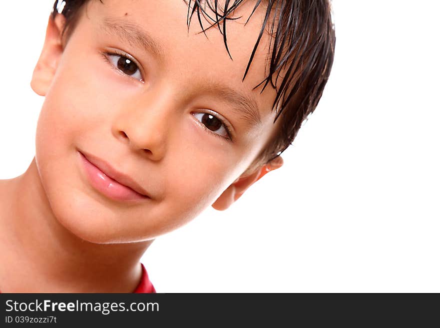 Happy child looking at the camera with a small smile over white background. Happy child looking at the camera with a small smile over white background