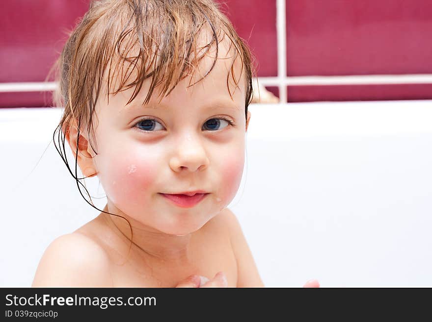 Girl Looking Out Of A Bath And Smiling