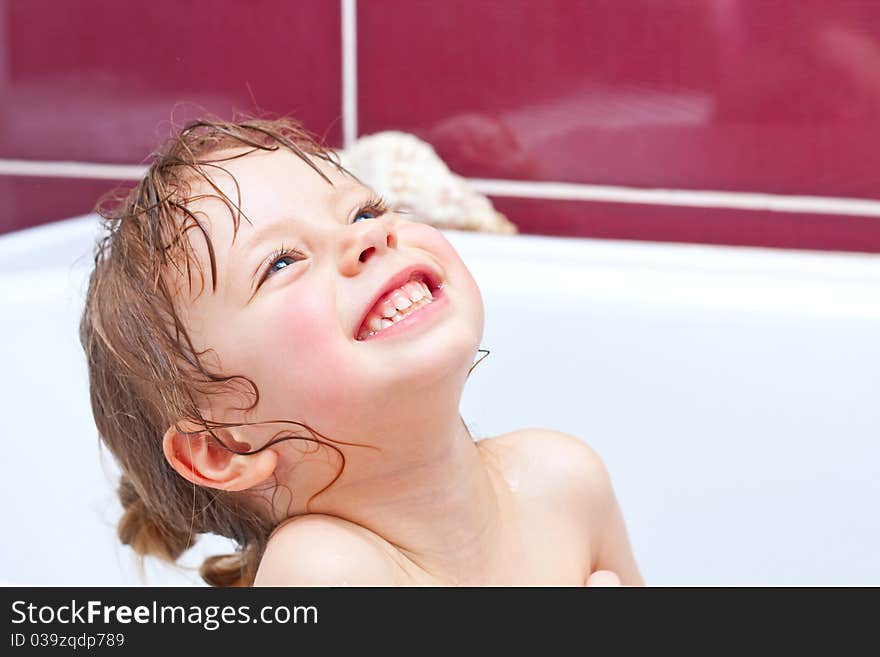 Girl Looking Out Of A Bath And Smiling