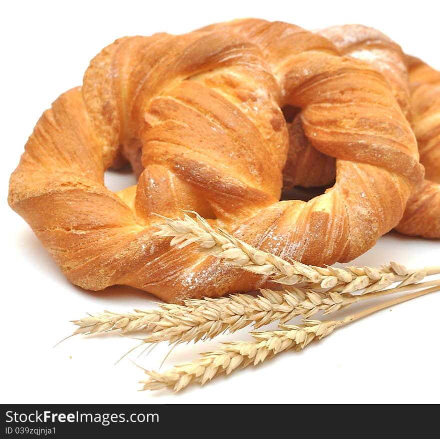 Bread with wheat ears on white background