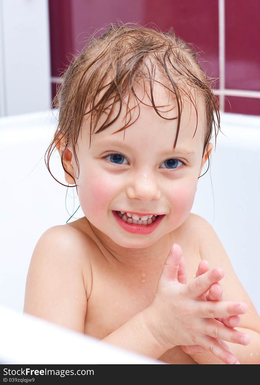 Girl Looking Out Of A Bath And Smiling