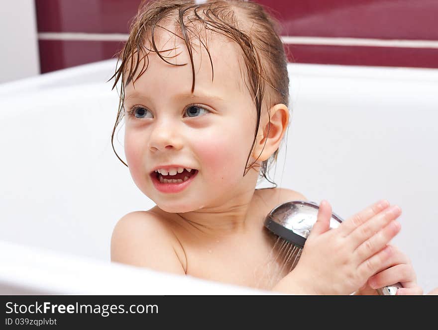 Girl Looking Out Of A Bath And Smiling