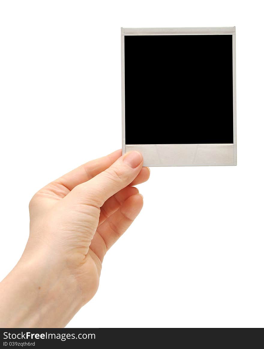 One instant photo in hand isolated on white background. One instant photo in hand isolated on white background