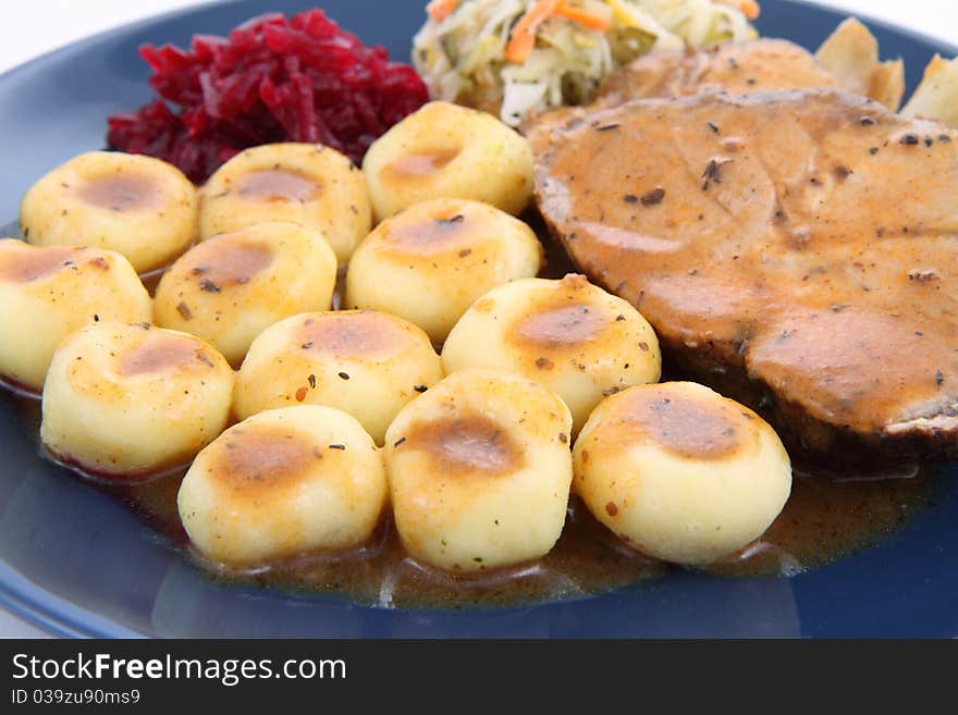 Pork steak and dumplings with side salads