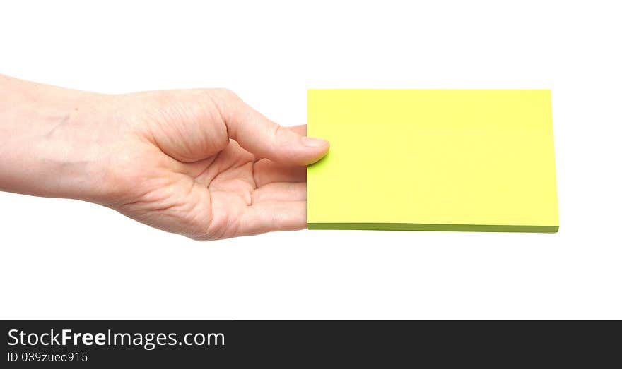 In the hands of a woman green paper on white