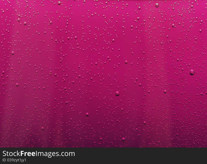 Water drops on abstract red surface