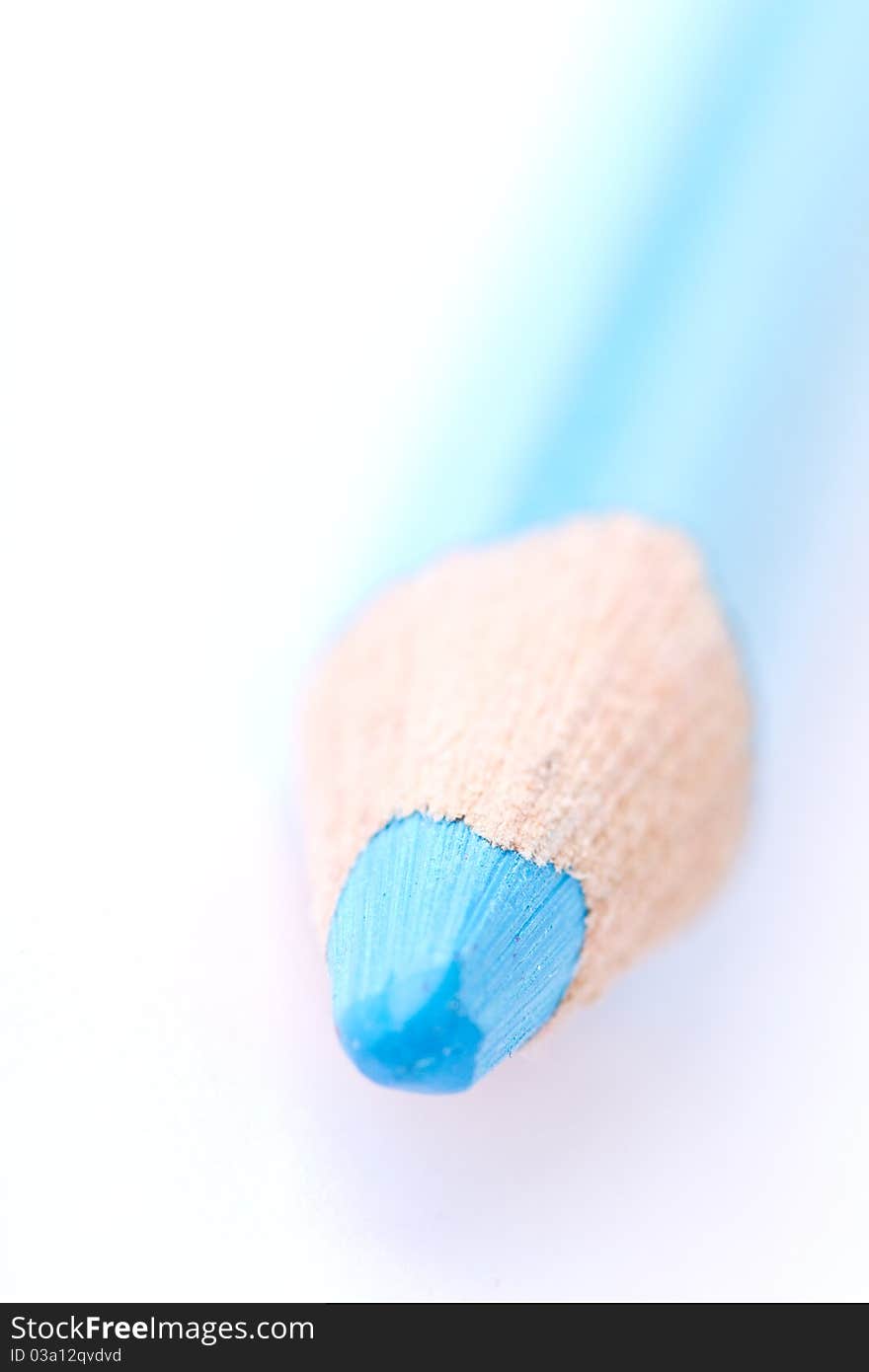 Closeup of a blue crayon isolated on a white backgrund. Has a shallow depth of field.