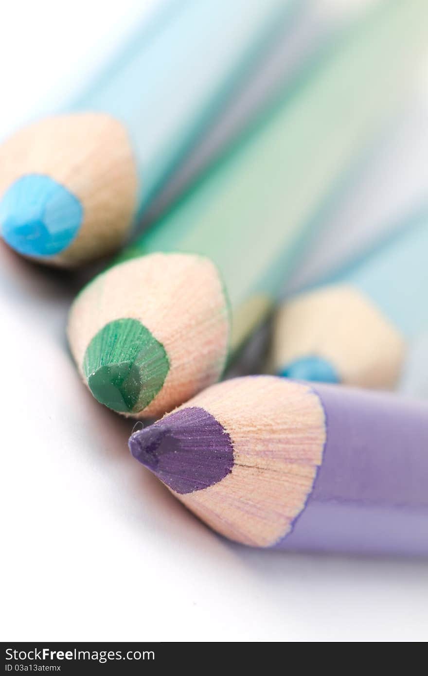 Four colorful crayons on white background with a shallow depth of field for effect. Four colorful crayons on white background with a shallow depth of field for effect.