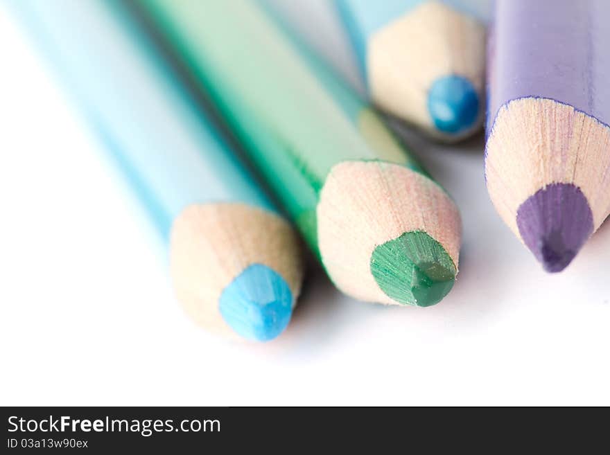 Four colorful crayons on white background with a shallow depth of field for effect. Four colorful crayons on white background with a shallow depth of field for effect.