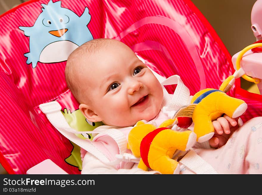 Happy baby sitting on a chair