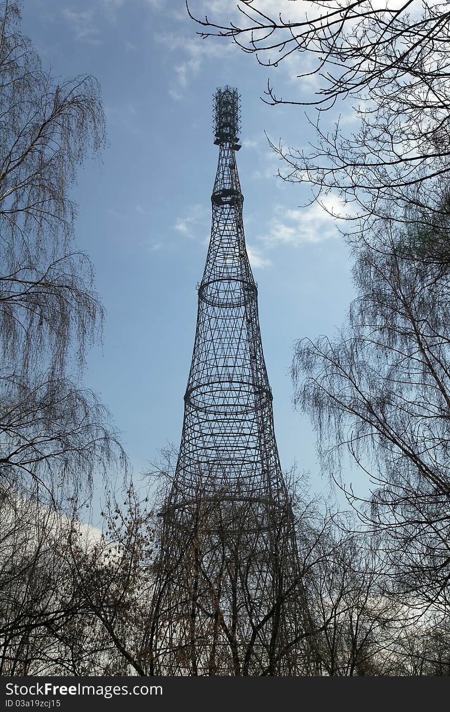 Shukhov radio and TV tower in Moscow, Russia among the trees. The Tower was built in 1922. Shukhov radio and TV tower in Moscow, Russia among the trees. The Tower was built in 1922.