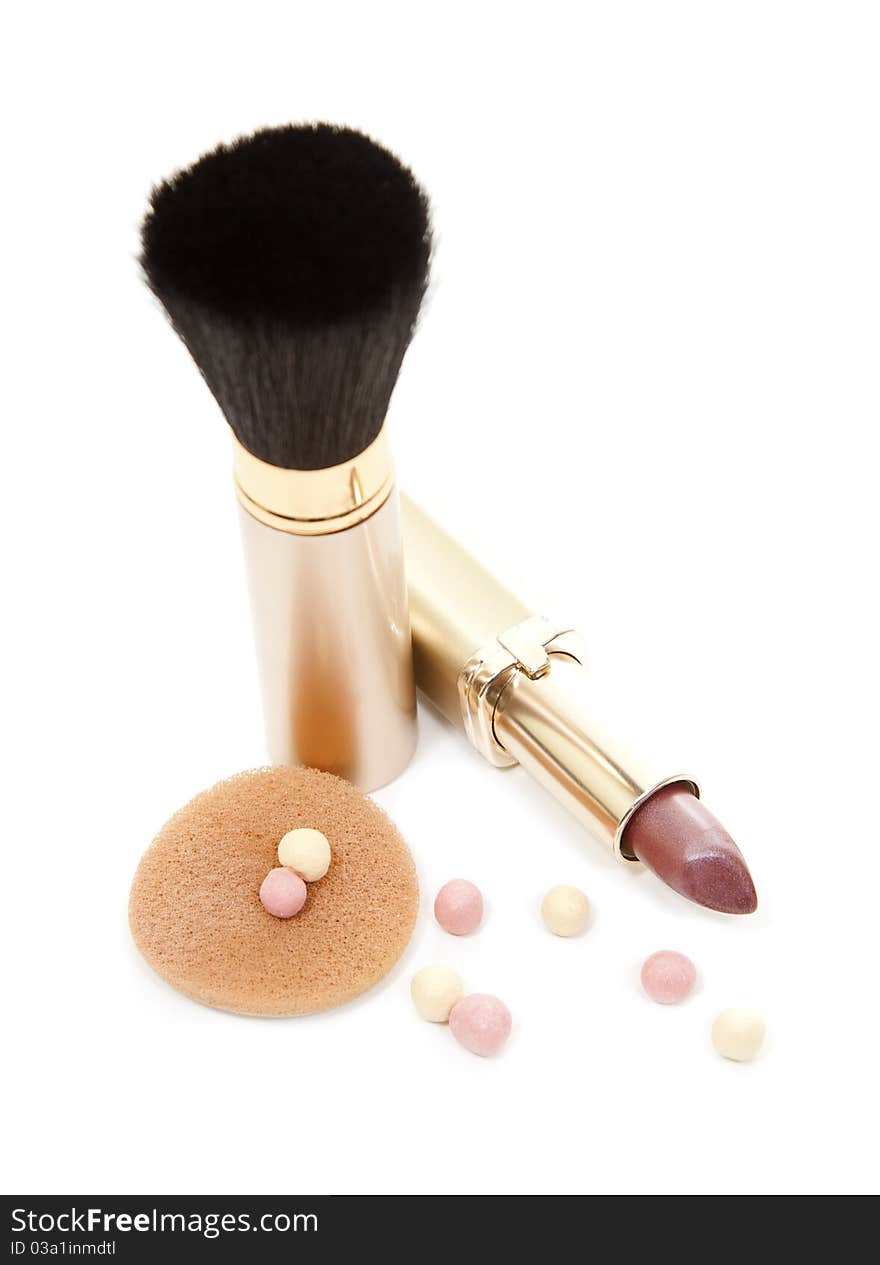 Isloated gold cosmetics accesories, brush and lipstick. Isloated gold cosmetics accesories, brush and lipstick