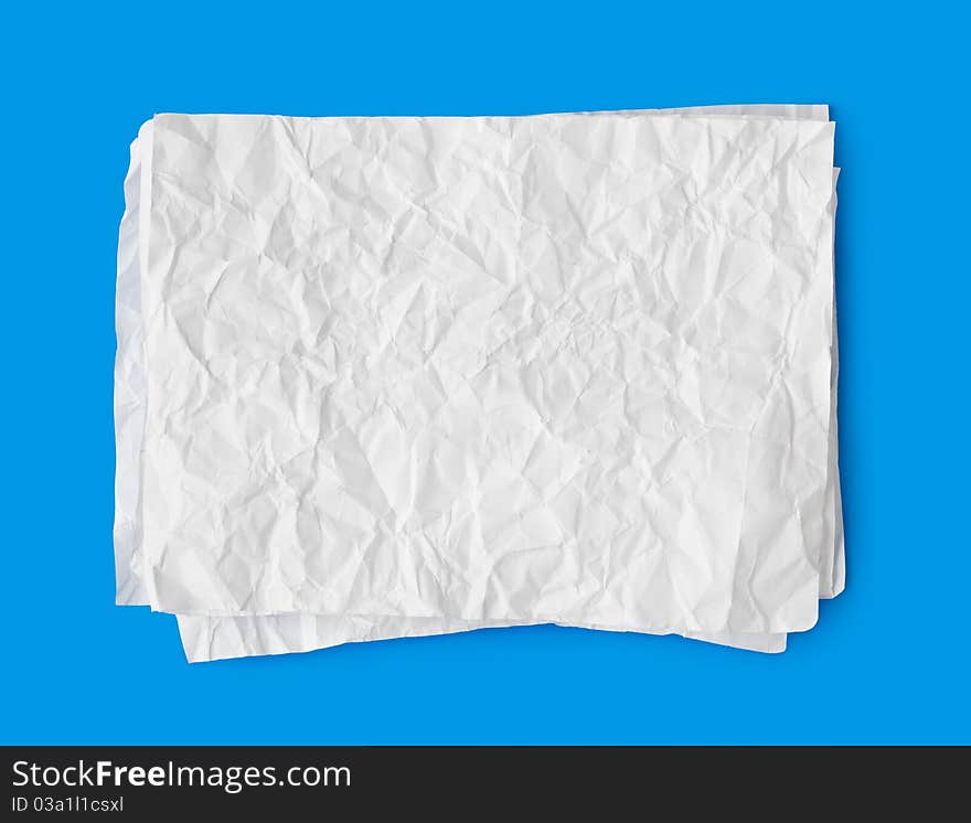 Crumpled paper stack isolated on blue background