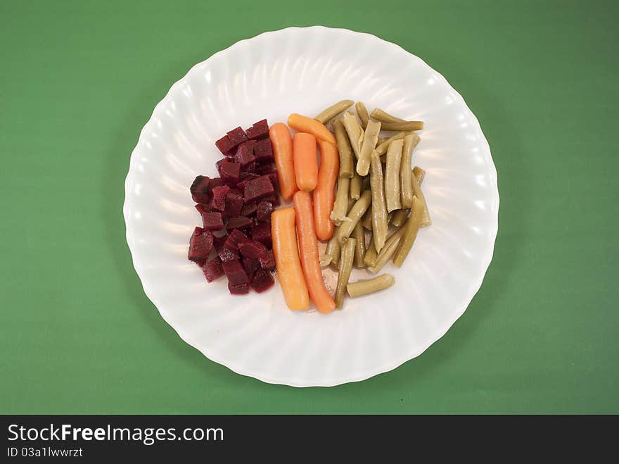 Vegetable plate with green background. Vegetable plate with green background