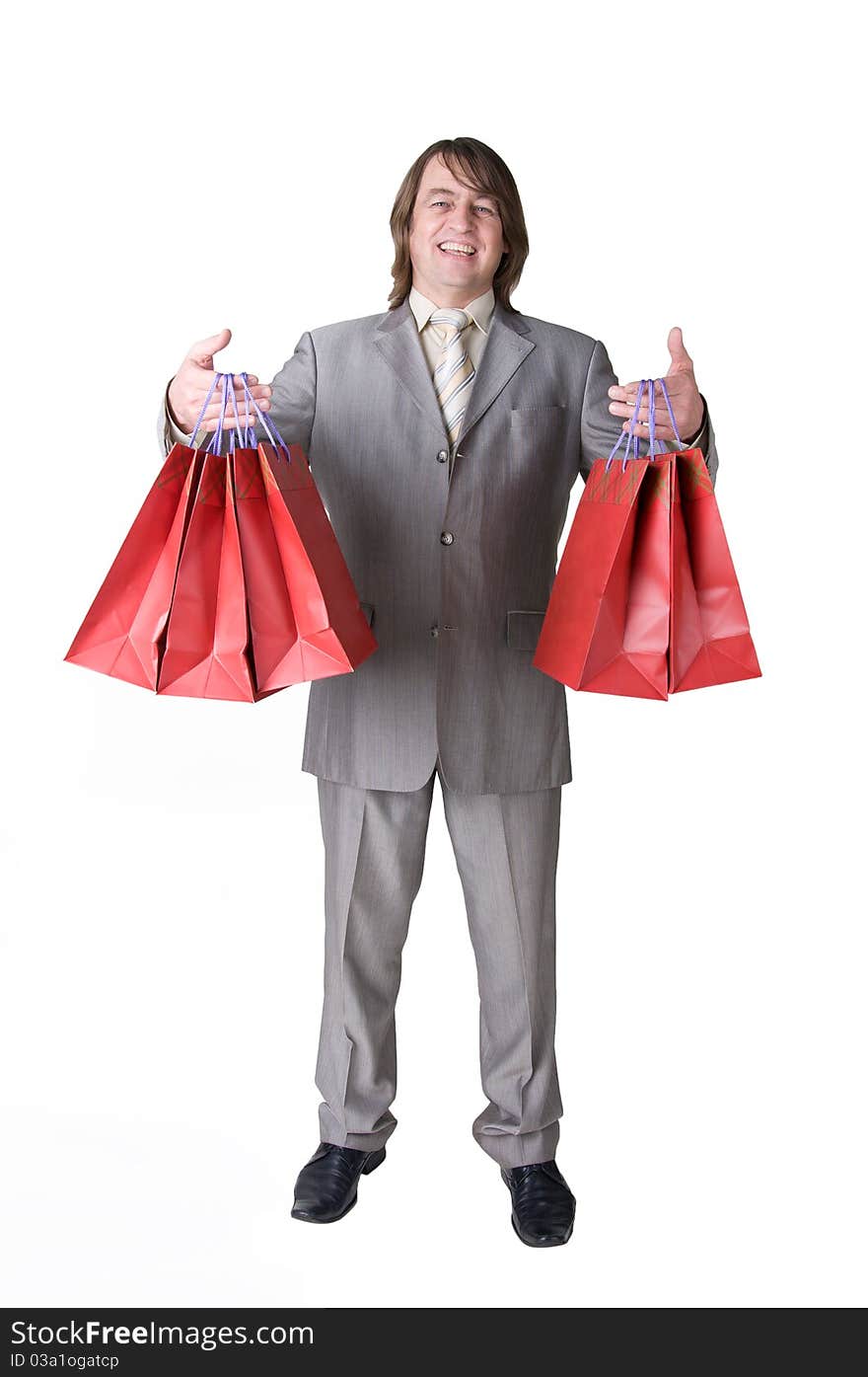 A man who smiles, holding shopping bags