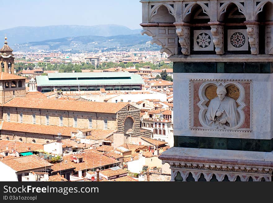 A tower with a statue on the foof of Basilica di Santa Maria del Fiore. A tower with a statue on the foof of Basilica di Santa Maria del Fiore