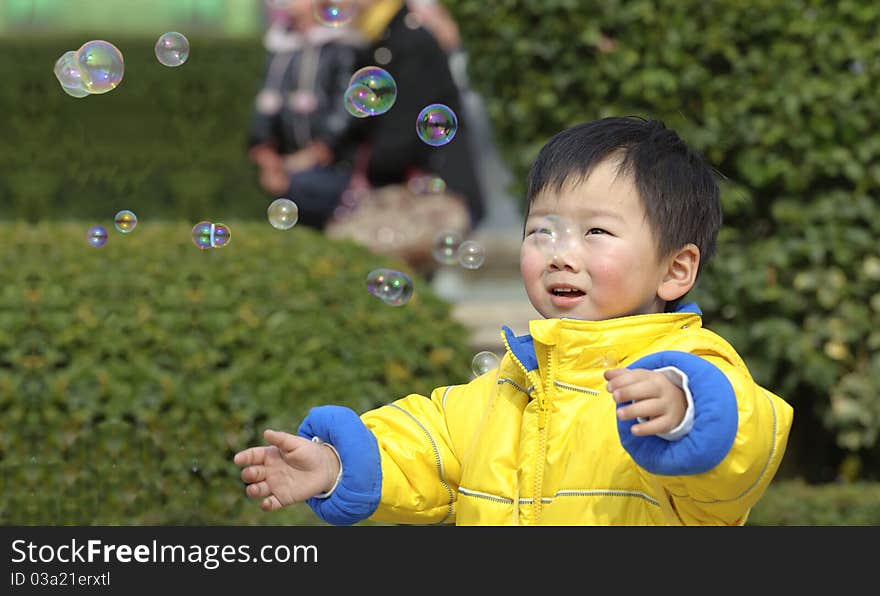 A baby is playing soap bubbles. A baby is playing soap bubbles