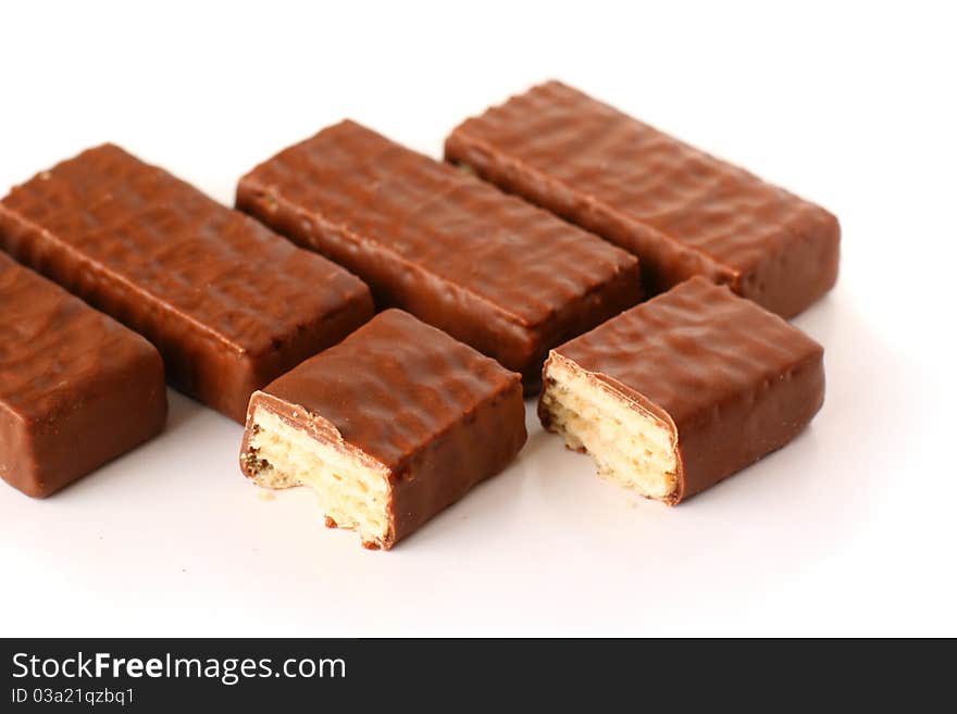 Row of a few chocolate wafers on white background