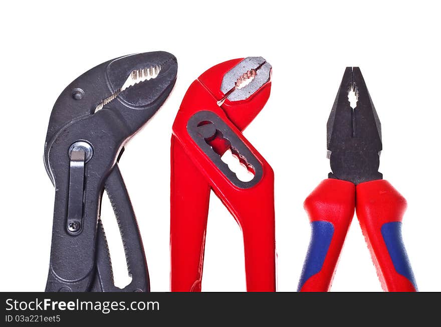 Alligator wrenches and pliers on white background close-up (isolated). Alligator wrenches and pliers on white background close-up (isolated).