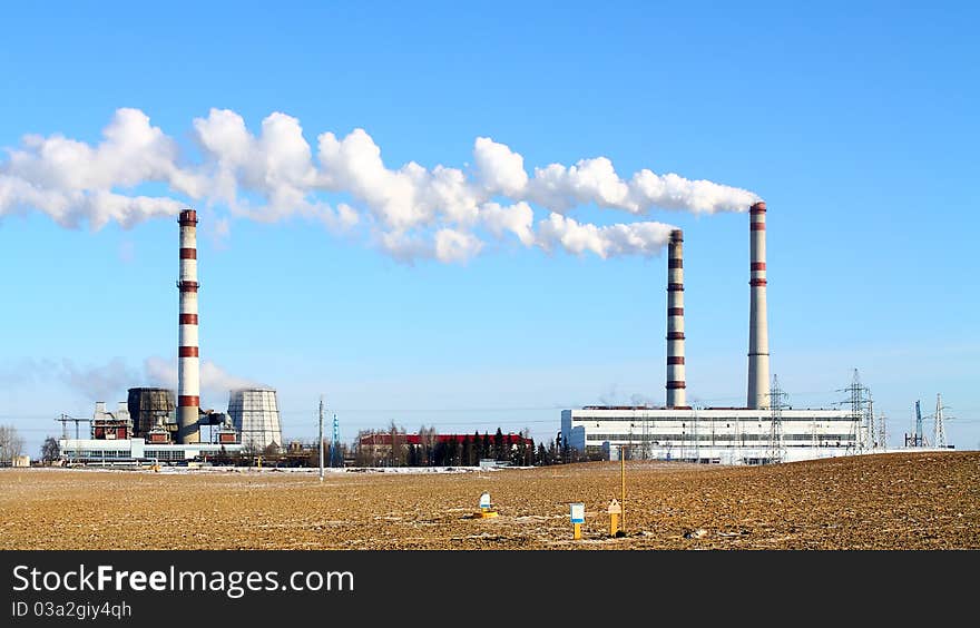 Smoking chimneys power against the blue sky. Smoking chimneys power against the blue sky