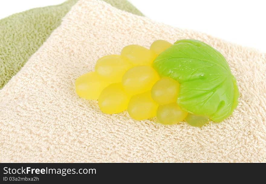 Natural green grape soap and towels on white background. Natural green grape soap and towels on white background.