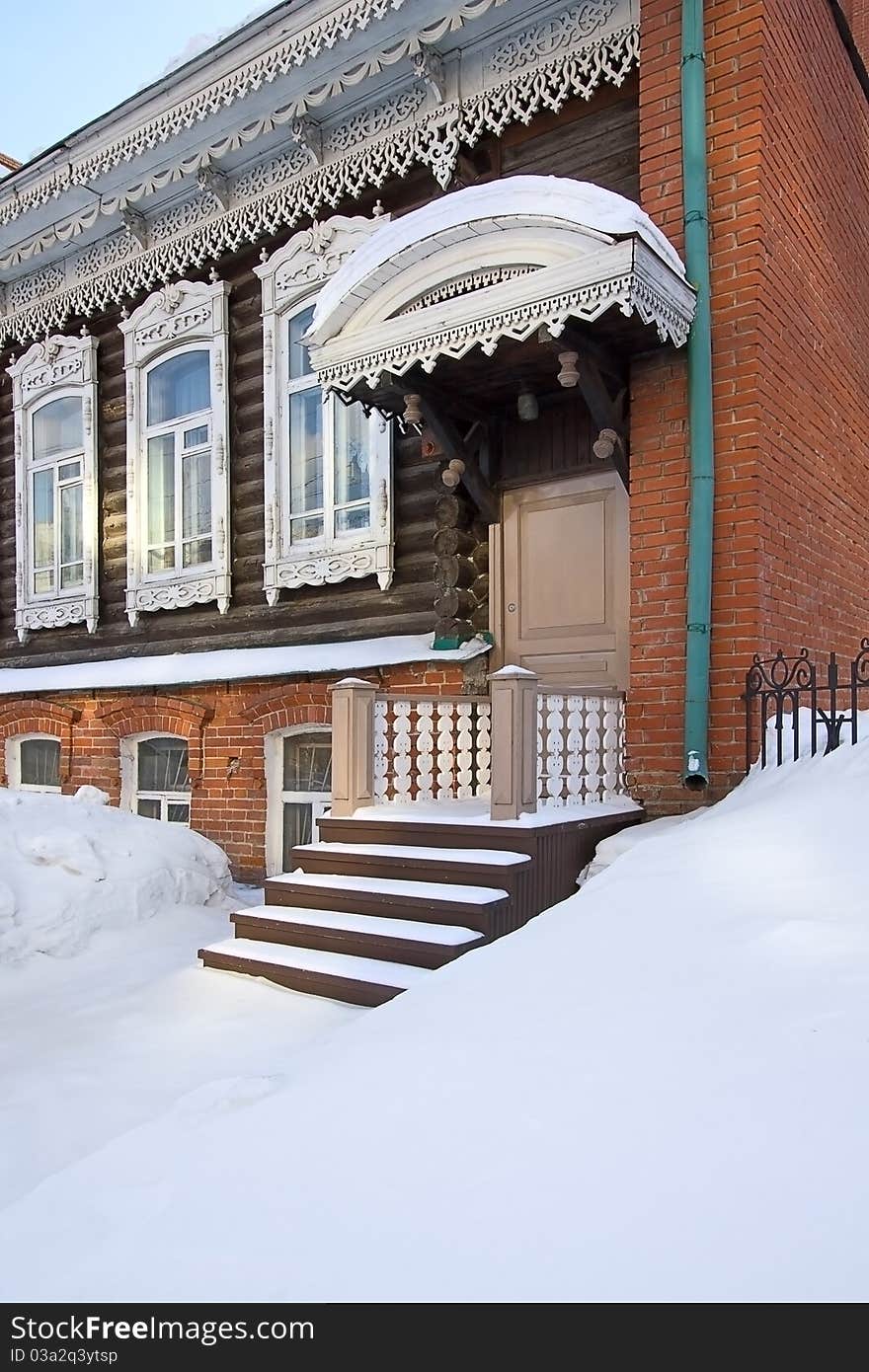 Winter. Snow lies on  porch of  old house, Russia.