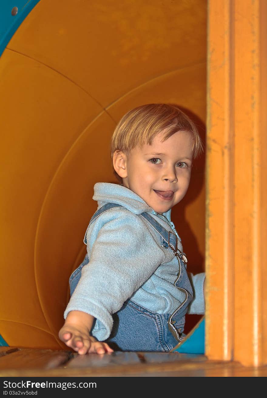 Boy in tube slide