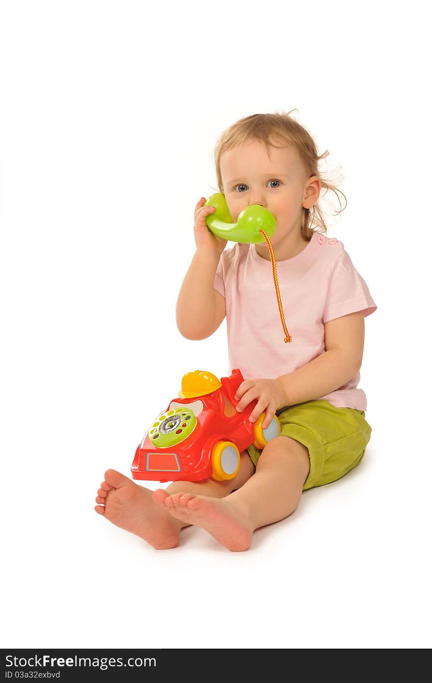 Baby in studiu is playing with toys