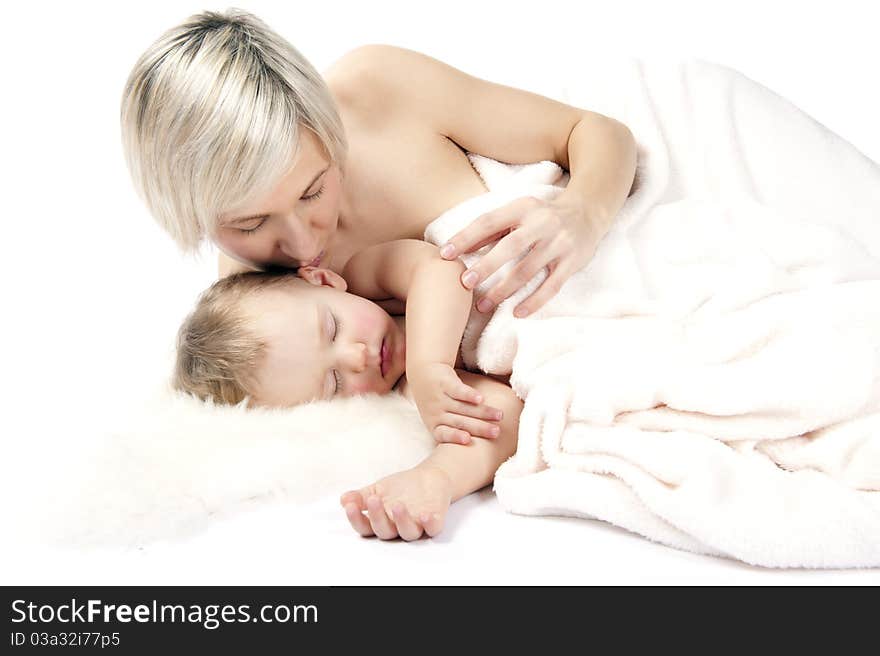 Mother with baby are sleeping in bed