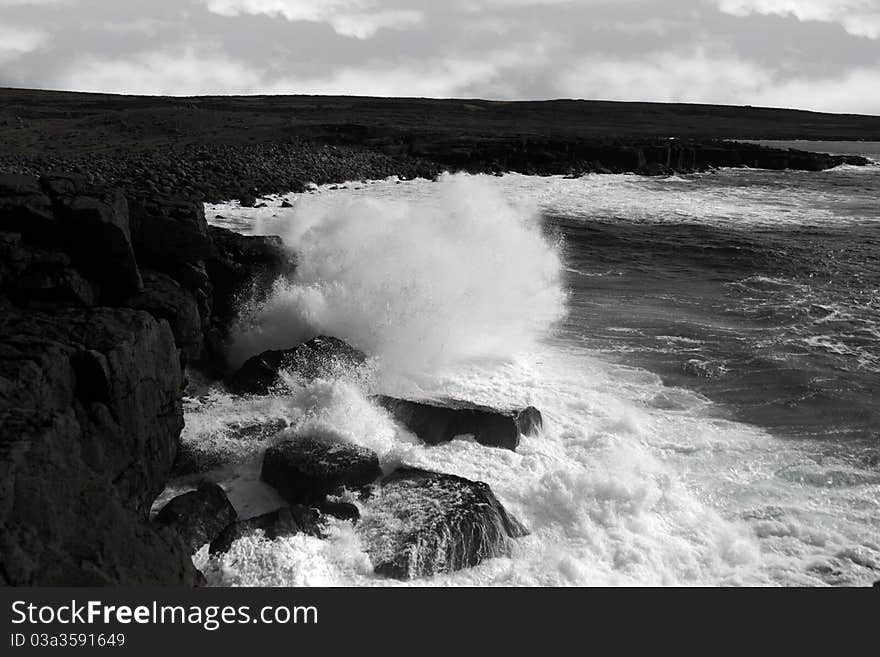 Giant storm waves crashing on coastline cliffs