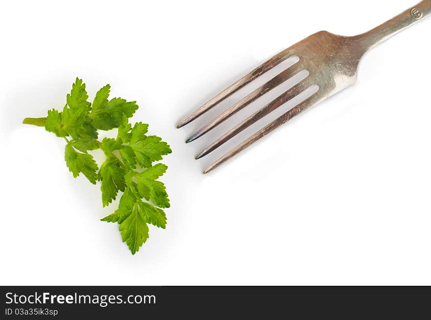 A parsley and a fork isolated on white background. A parsley and a fork isolated on white background