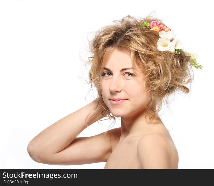 Portrait of the beauty young blond girl with freesia in her hair