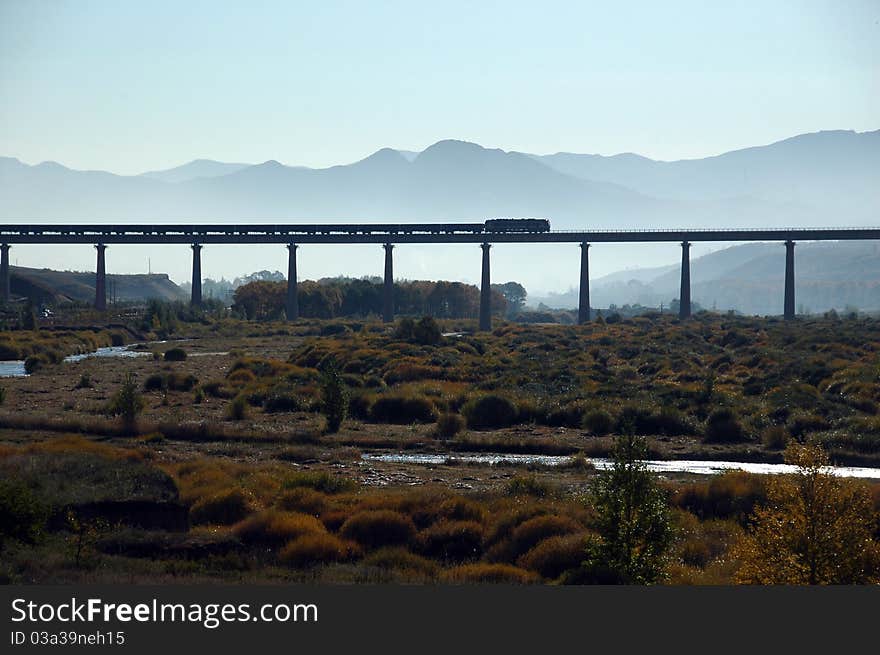 A railway bridge across open field. A railway bridge across open field