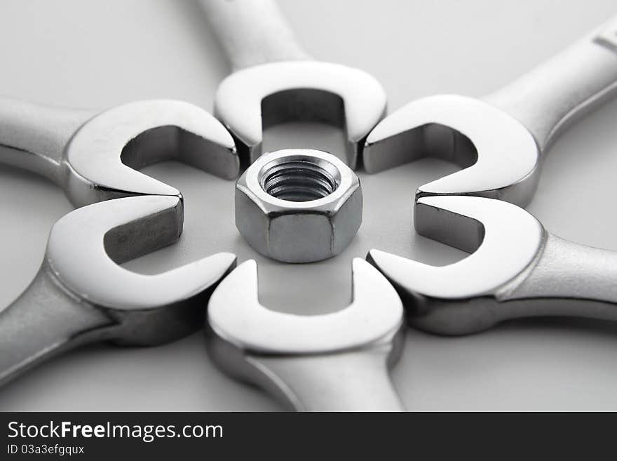 Wrenches and hardware in various patterns on a white background. Wrenches and hardware in various patterns on a white background