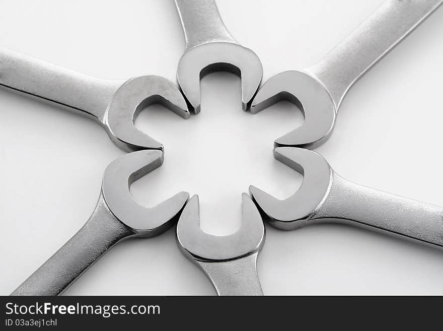 Wrenches and hardware in various patterns on a white background. Wrenches and hardware in various patterns on a white background