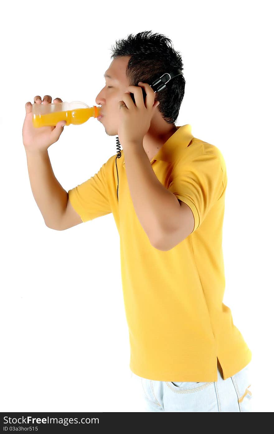 a young man was drinking a bottle of orange juice isolated on white background