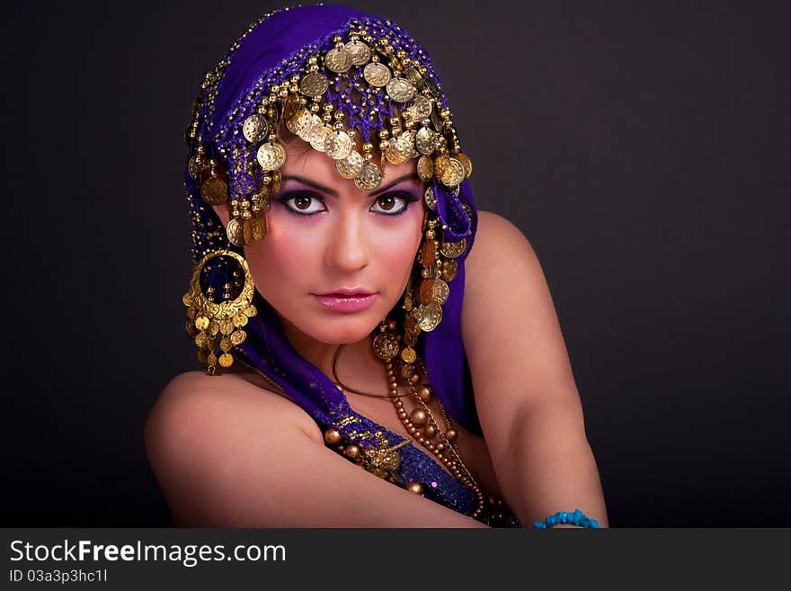 Beautiful girl in a stylized ethnic costume and shawl