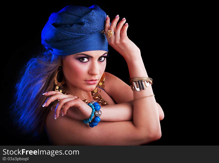 Beautiful girl in a turban and a stylized ethnic costume